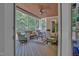 Enclosed sunroom with comfortable seating, wood ceiling, and natural light, ideal for relaxing at 216 Colonial Ridge Dr, Pittsboro, NC 27312