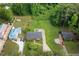 An aerial view showcases this home's location among lush trees and beautiful surrounding homes at 2315 Oxford Rd, Henderson, NC 27536