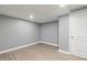 Basement room featuring vinyl floors, neutral paint, and a modern lighting fixture at 2315 Oxford Rd, Henderson, NC 27536