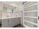 Stylish bathroom with a double vanity, marble counters, and modern sliding door at 2315 Oxford Rd, Henderson, NC 27536