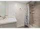 Bathroom features modern vanity, framed mirror, and walk-in shower with grey tiling and shower caddy at 2315 Oxford Rd, Henderson, NC 27536