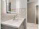 Modern bathroom featuring a vanity with a light-up mirror and beautiful marble tiling at 2315 Oxford Rd, Henderson, NC 27536