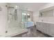 Modern bathroom with a glass shower, soaking tub, and double vanity at 2315 Oxford Rd, Henderson, NC 27536