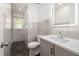 Modern bathroom featuring a sleek vanity, toilet, and a glass enclosed shower with marble flooring at 2315 Oxford Rd, Henderson, NC 27536