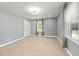 Spacious bedroom with carpet flooring, neutral walls, and natural light at 2315 Oxford Rd, Henderson, NC 27536