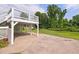 Exterior view showing white deck with lush trees in the background at 2315 Oxford Rd, Henderson, NC 27536