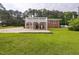 The brick house features an elevated deck, covered patio, and spacious yard, perfect for outdoor living at 2315 Oxford Rd, Henderson, NC 27536