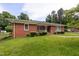 Charming brick home with a manicured lawn, walkway, mature trees and shrubs for great curb appeal at 2315 Oxford Rd, Henderson, NC 27536