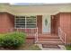 Inviting front porch with brick steps, decorative railing, and a 'Home Sweet Home' welcome mat at 2315 Oxford Rd, Henderson, NC 27536