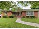 Charming brick home with a manicured lawn, walkway, mature trees and shrubs for great curb appeal at 2315 Oxford Rd, Henderson, NC 27536