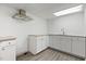 Kitchen featuring white cabinets, granite countertops, stainless steel exhaust fan and grey vinyl flooring at 2315 Oxford Rd, Henderson, NC 27536