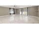 Spacious living room showcasing marble floors, natural light from many windows, and ceiling fan at 2315 Oxford Rd, Henderson, NC 27536