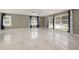 Spacious living room showcasing marble floors, natural light from many windows, and ceiling fan at 2315 Oxford Rd, Henderson, NC 27536