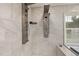 This modern shower system features rainfall and massage settings, surrounded by tiled walls and a glass enclosure at 2315 Oxford Rd, Henderson, NC 27536