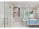 Modern glass enclosed shower with multiple jets, surrounded by tiled walls and marble flooring at 2315 Oxford Rd, Henderson, NC 27536