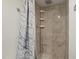 Bathroom featuring tiled shower and sleek shower head with a white curtain at 2315 Oxford Rd, Henderson, NC 27536