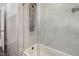 Tiled bathtub featuring glass doors and a modern shower column with various settings at 2315 Oxford Rd, Henderson, NC 27536
