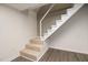 Stairway with carpeted steps, painted white, contrasting against the vinyl plank flooring at 2315 Oxford Rd, Henderson, NC 27536