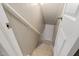 Stairway featuring carpeted steps and white railing, leading to the lower level at 2315 Oxford Rd, Henderson, NC 27536