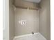 Utility room with white tile flooring, wood shelving, and beige painted walls at 2315 Oxford Rd, Henderson, NC 27536