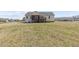 Spacious backyard features a well-maintained lawn and the back of the home at 25 Mannford Ln, Angier, NC 27501