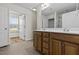 Bathroom featuring double sinks, wood cabinets, and access to natural light at 25 Mannford Ln, Angier, NC 27501