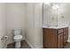 Neutral half bath features a wooden vanity with double sinks and a toilet at 25 Mannford Ln, Angier, NC 27501