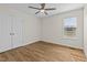 Bright bedroom with hardwood floors, ceiling fan, and closet for ample storage at 25 Mannford Ln, Angier, NC 27501
