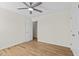 Well-lit bedroom features hardwood flooring and a bright white closet door at 25 Mannford Ln, Angier, NC 27501
