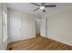Cozy bedroom with hardwood floors, a ceiling fan, and a closet for storage at 25 Mannford Ln, Angier, NC 27501