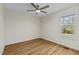 Bright bedroom featuring hardwood floors, a ceiling fan, and a window for natural light at 25 Mannford Ln, Angier, NC 27501