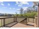 This deck has brown wood and overlooks the backyard with the sky and clouds in the background at 25 Mannford Ln, Angier, NC 27501