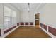 Elegant dining room with hardwood floors, tray ceiling, and wainscoting at 25 Mannford Ln, Angier, NC 27501