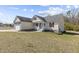 Side view of a cozy house with a two-car garage and a well-maintained lawn at 25 Mannford Ln, Angier, NC 27501
