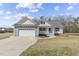 Charming single-Gathering home featuring a two-car garage and welcoming front porch with red shutters at 25 Mannford Ln, Angier, NC 27501