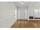 Bright foyer with hardwood floors, white trim, and sidelight windows flanking the front door at 25 Mannford Ln, Angier, NC 27501