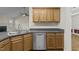 Kitchen area featuring stainless steel appliances, wood cabinets and hardwood floors throughout the house at 25 Mannford Ln, Angier, NC 27501