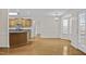 Spacious kitchen featuring wood cabinets and light filled breakfast nook, with hardwood floors and stainless steel appliances at 25 Mannford Ln, Angier, NC 27501