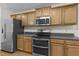 Modern kitchen equipped with stainless steel appliances, wood cabinets and lots of countertop space at 25 Mannford Ln, Angier, NC 27501