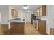Kitchen boasts stainless steel appliances, a breakfast bar, and wood cabinets, providing a functional cooking space at 25 Mannford Ln, Angier, NC 27501