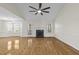 Inviting living room featuring a fireplace, ceiling fan, and access to the back patio at 25 Mannford Ln, Angier, NC 27501