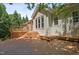 A large, multi-level back deck with wood floors and a stone accent wall is perfect for entertaining at 2709 Penfold Ln, Wake Forest, NC 27587
