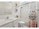Bright bathroom with a single vanity, toilet and a tub/shower combo with a butterfly curtain at 2709 Penfold Ln, Wake Forest, NC 27587