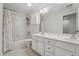 Bright bathroom featuring white tile, double sinks, and a bathtub with shower at 2709 Penfold Ln, Wake Forest, NC 27587