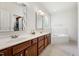 Bright bathroom featuring a double sink vanity, soaking tub, and neutral tiling at 2709 Penfold Ln, Wake Forest, NC 27587