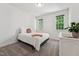 Bright bedroom with neutral carpet, and a plant near the white painted furniture at 2709 Penfold Ln, Wake Forest, NC 27587