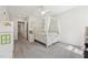 Bedroom featuring canopy bed, ceiling fan, and natural light from a window at 2709 Penfold Ln, Wake Forest, NC 27587