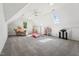 Bright, spacious bonus room with a gymnastic bar, toys and natural light from a skylight and window at 2709 Penfold Ln, Wake Forest, NC 27587