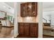 A butler's pantry includes custom wood cabinets and granite countertops with easy access to the living spaces at 2709 Penfold Ln, Wake Forest, NC 27587