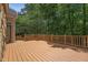 Spacious wooden deck with railing overlooking a lush, green backyard with mature trees at 2709 Penfold Ln, Wake Forest, NC 27587